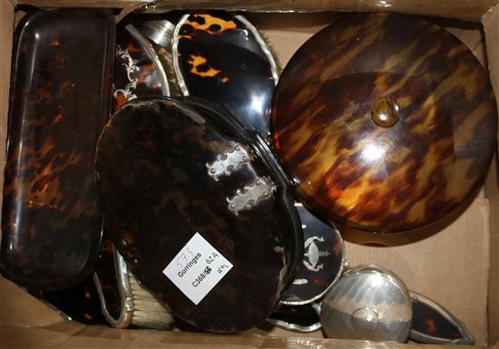 A silver and tortoiseshell harlequin dressing table set with related jars, dishes, etc.